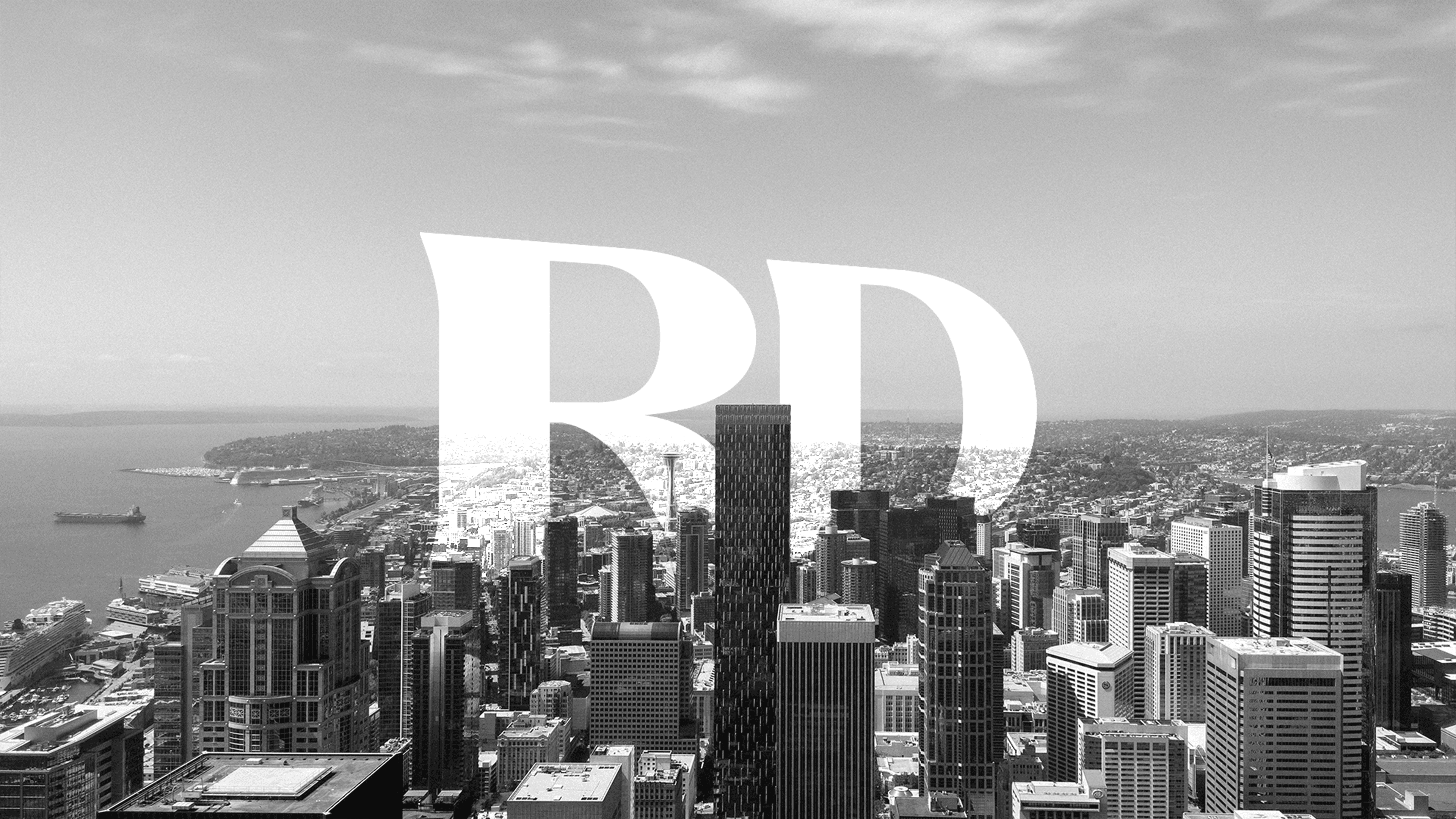 Seattle cityscape with Rough Draft Media logo
